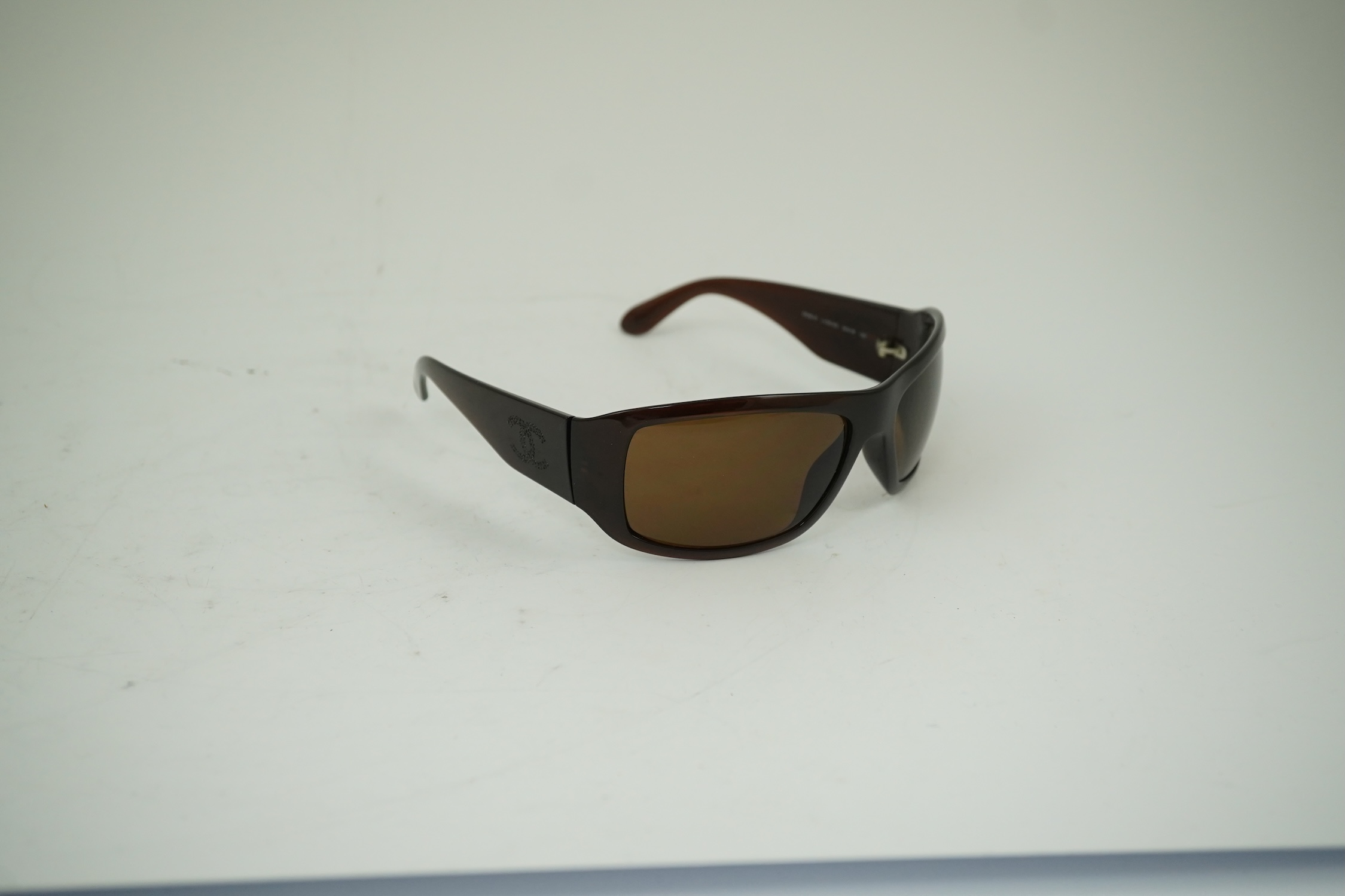 A pair of lady's brown Chanel sunglasses with hard case